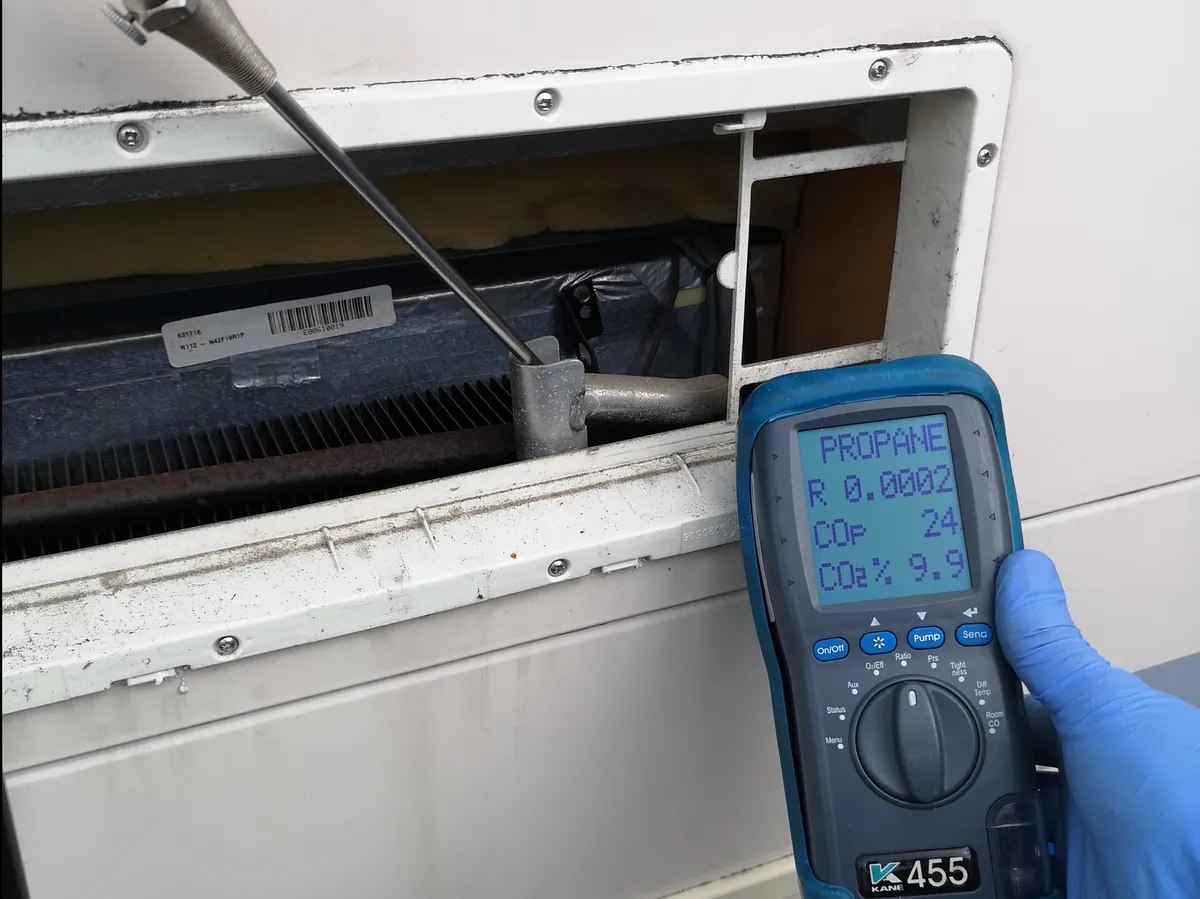 Gas Safe Registered Engineer. a hand holding a device with a screen