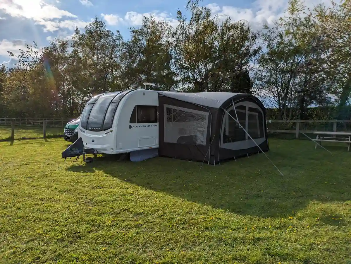 a camper on a grass field